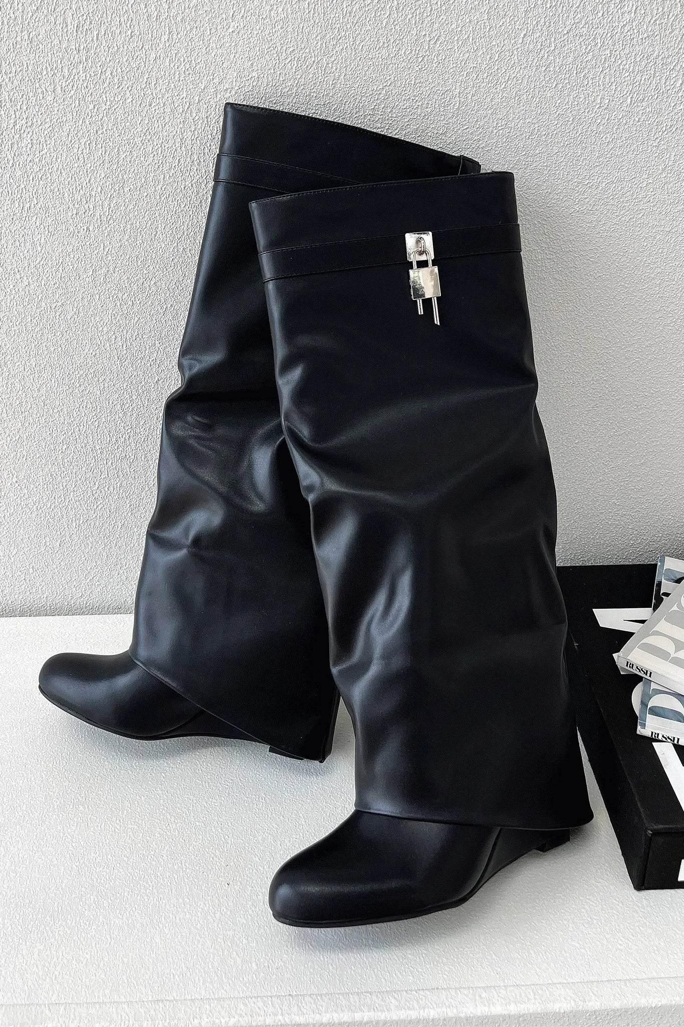 Women's black faux leather knee-high boots with pointed toe and slouchy shaft